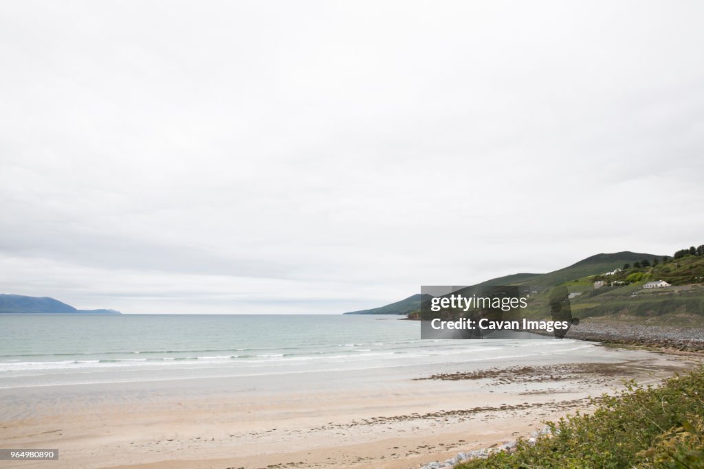 Scenic view of Inch beach against cloudy sky