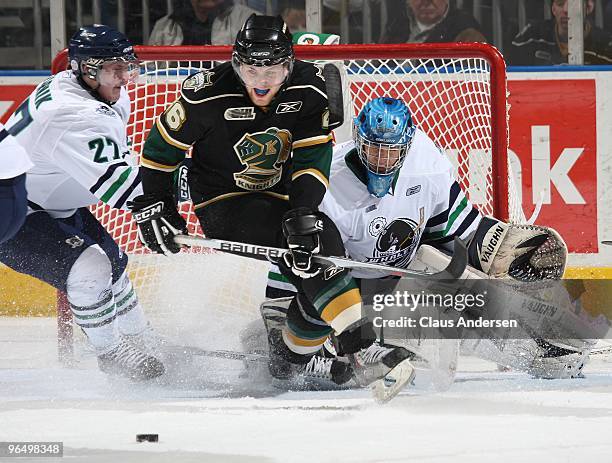 Colin Martin of the London Knights crashes the net of Matt Hackett of the Plymouth Whalers in a game on February 5, 2010 at the John Labatt Centre in...