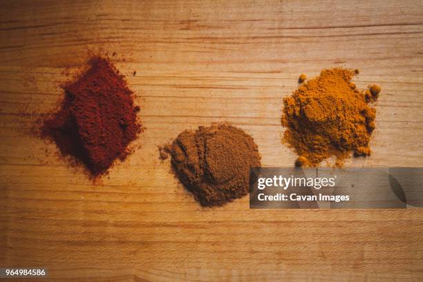 overhead view of various spices on wooden table - garam masala stock pictures, royalty-free photos & images