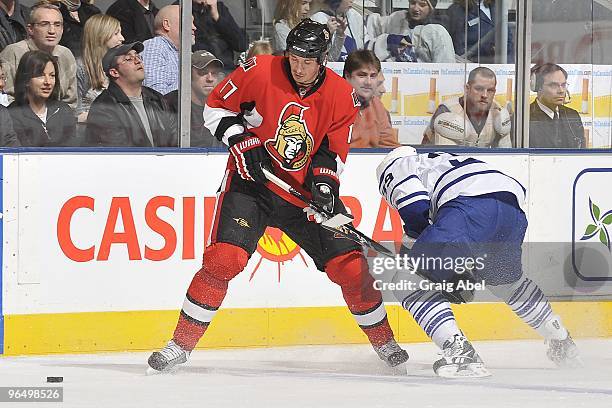 John Mitchell of the Toronto Maple Leafs battles for the puck with Filip Kuba of the Ottawa Senators during the game on February 6, 2010 at the Air...