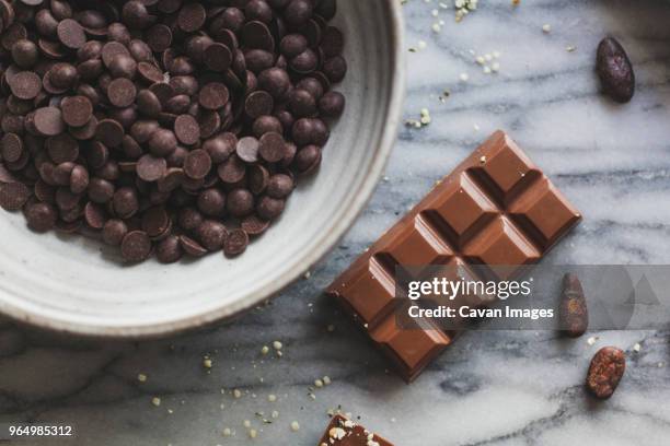 high angle view of chocolate bar with chips on kitchen counter - chocolate chip stock-fotos und bilder