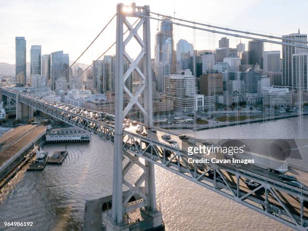 high angle view of cars moving on oakland bay bridge over sea against sky in city - oakland stockfoto's en -beelden