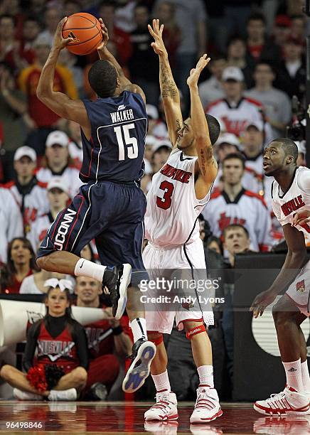 Peyton Siva of the Louisville Cardinals defends Kemba Walker of the Connecticut Huskies during the Big East Conference game on February 1, 2010 at...