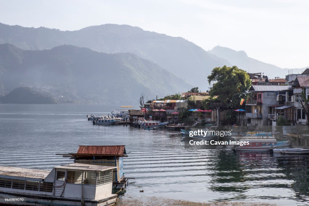 High angle view of boats moored on lake against mountains
