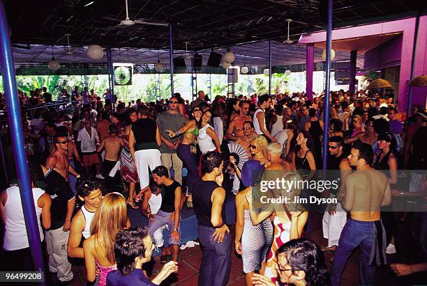 Clubbers enjoy the atmosphere during the after party of the opening night of the season for Manumission, on the terrace at Space in June 2001, in...
