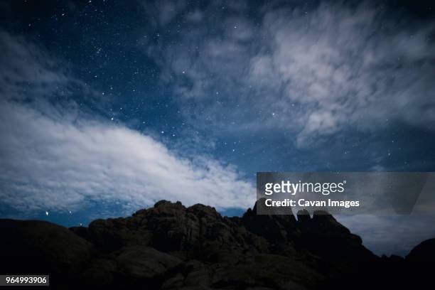 scenic view of rock formation against stary sky at night - stary night stock pictures, royalty-free photos & images