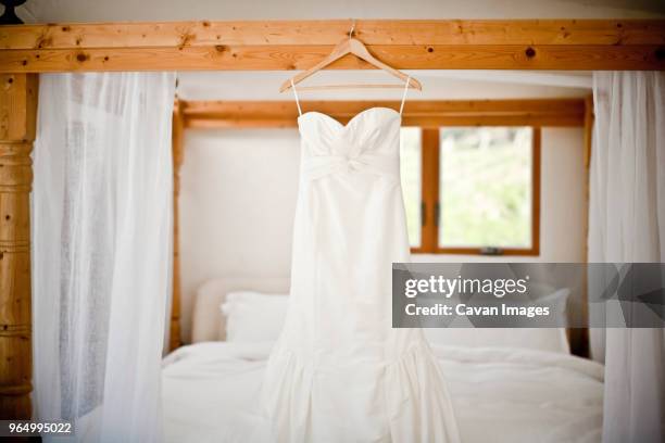 wedding dress hanging bed - wedding dress on hanger stock pictures, royalty-free photos & images