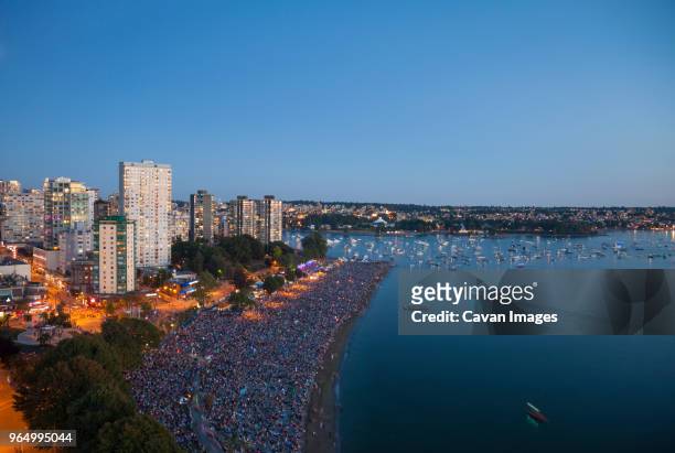 high angle view of people at english bay against clear blue sky - english bay stock-fotos und bilder