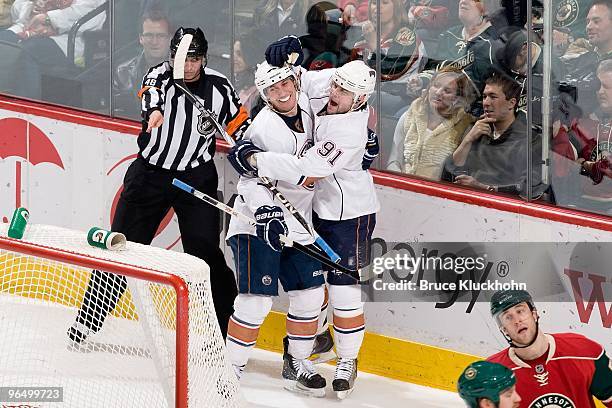Mike Comrie celebrates after scoring a goal with his Edmonton Oilers teammate Sam Gagner against the Minnesota Wild during the game at the Xcel...