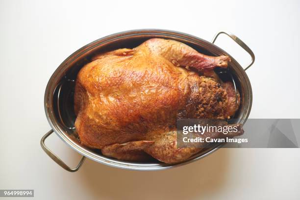 overhead view of roasted turkey meat in container against white background - chicken on white stockfoto's en -beelden