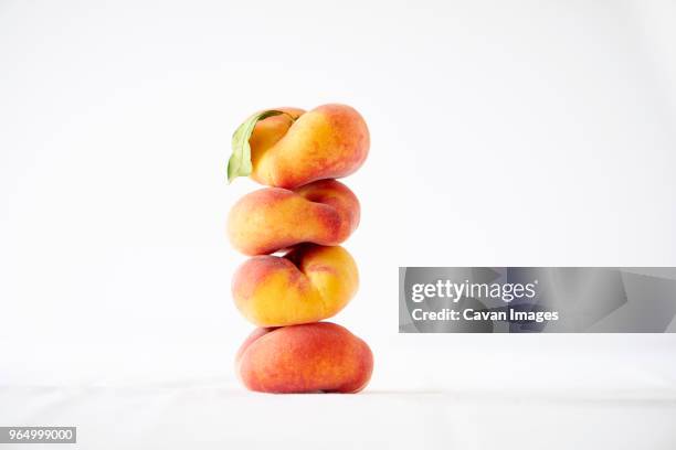 stack of peaches against white background - peach on white stock pictures, royalty-free photos & images