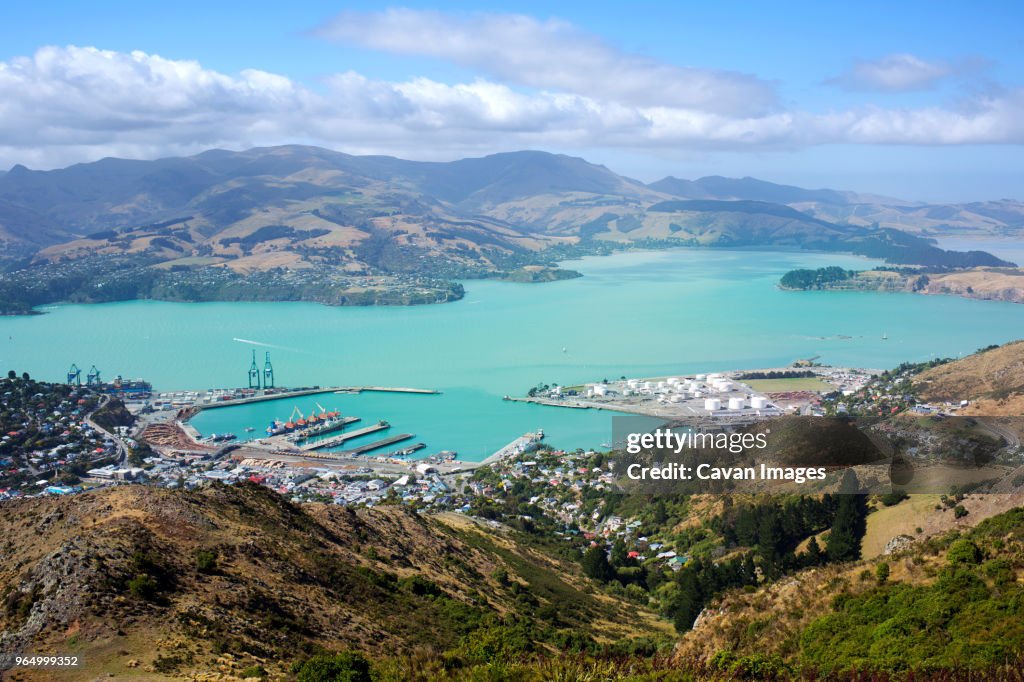 Aerial view of Lyttelton Harbour amidst landscape on sunny day