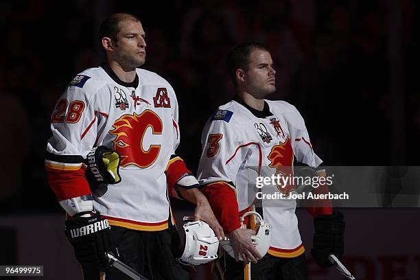 Robyn Regehr and Ian White of the Calgary Flames stand on the blue line during the playing of "O Canada" prior to the game against the Florida...