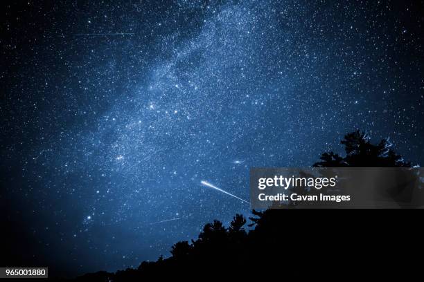low angle view of star field at night - stelle cadenti foto e immagini stock