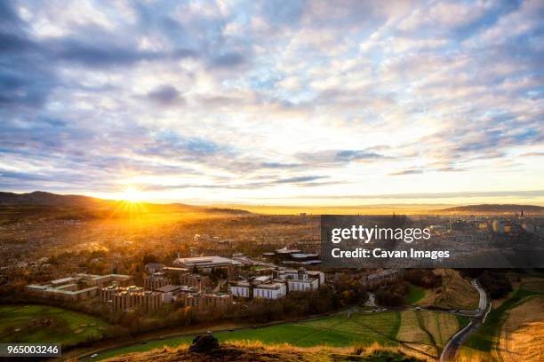 high angle view of cityscape against cloudy sky during sunrise - edinburgh foto e immagini stock