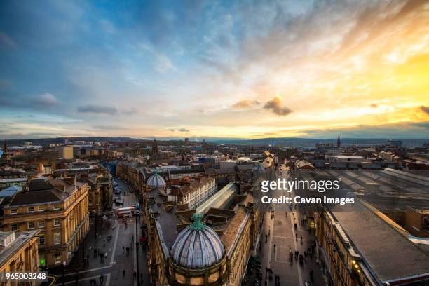 high angle view of grey street amidst city against cloudy sky during sunset - newcastle upon tyne stock pictures, royalty-free photos & images