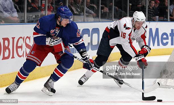 Eric Fehr of the Washington Capitals skates against Artem Anisimov of the New York Rangers on February 4, 2010 at Madison Square Garden in New York...