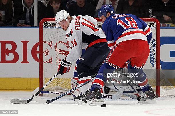 Tomas Fleischmann of the Washington Capitals skates against Marc Staal of the New York Rangers on February 4, 2010 at Madison Square Garden in New...