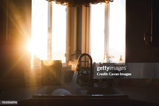 sunlight emitting through window in kitchen at home - sun rays through window stock pictures, royalty-free photos & images