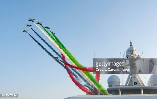 low angle view of airshow against clear sky - abu dhabi flag stock pictures, royalty-free photos & images