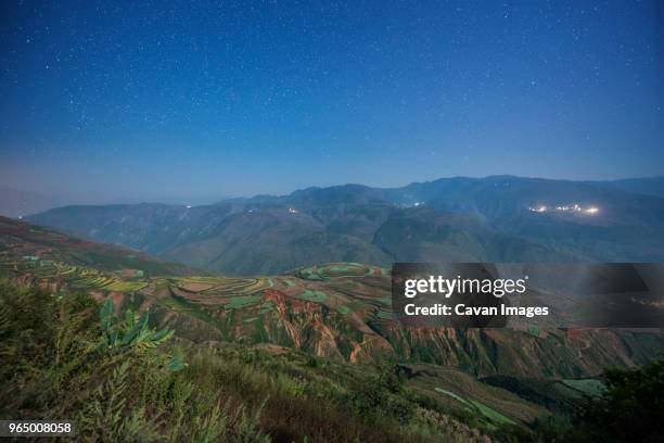 high angle majestic view of mountains against star field - 東城 ストックフォトと画像