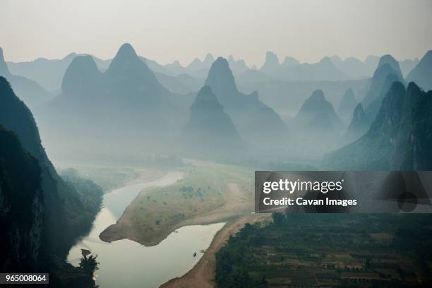 high angle idyllic view of mountain ranges during foggy weather - xingping stock pictures, royalty-free photos & images
