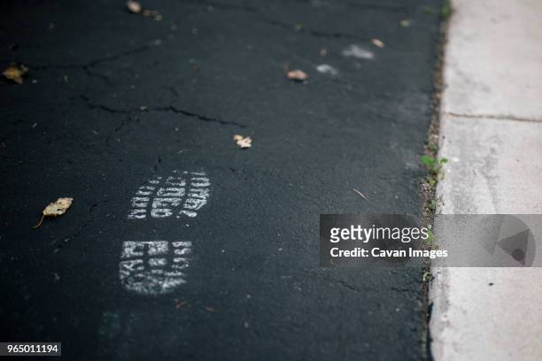 close-up of shoe print on road - schuhabdruck stock-fotos und bilder