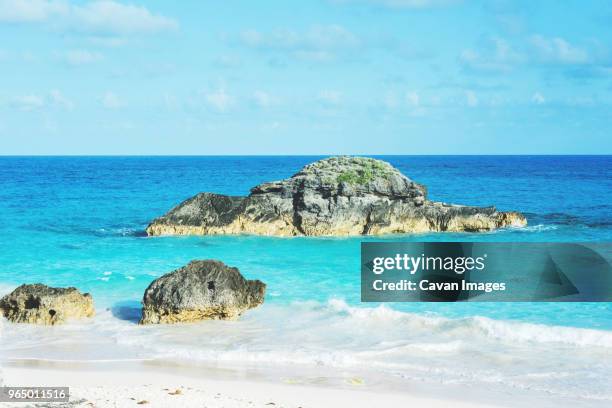 scenic view of rocks in sea against sky - southampton parish stock pictures, royalty-free photos & images