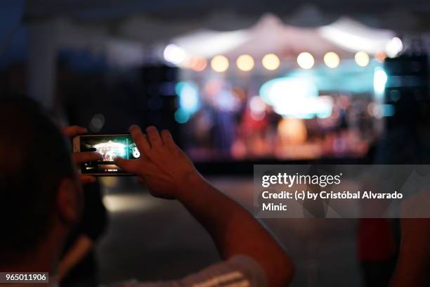 man photographing concert - alvarado minic stock pictures, royalty-free photos & images