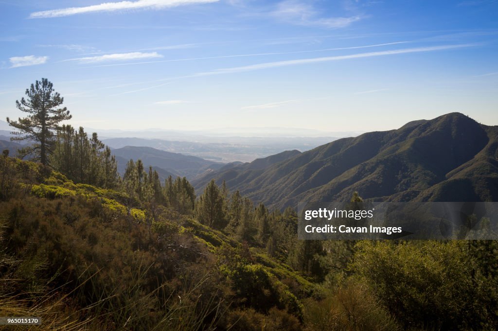 Scenic view of mountains against sky during sunny day