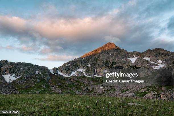 field by mountains at white river national forest against sky during winter - white river national forest stock pictures, royalty-free photos & images