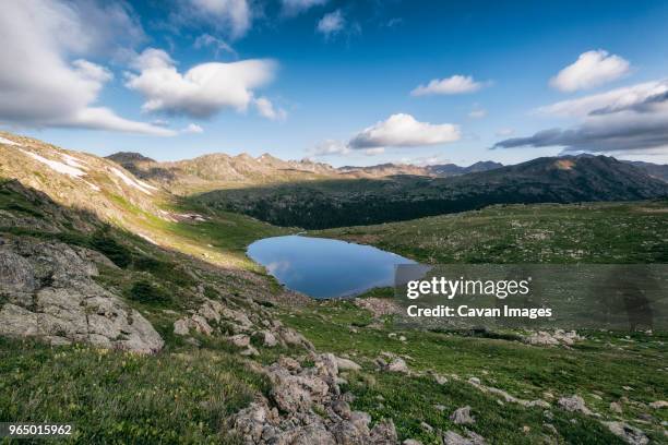 lake amidst field at white river national forest against sky - white river national forest stock-fotos und bilder