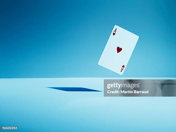 ace of hearts playing card in mid-air - ace photos et images de collection