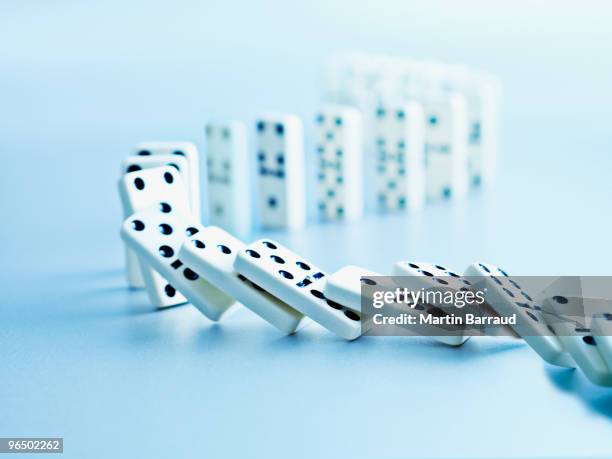 dominoes falling in a row - risk concept stock pictures, royalty-free photos & images