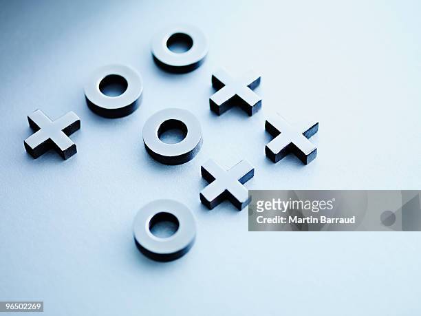 metal tic-tac-toe game pieces - tic tac stock pictures, royalty-free photos & images