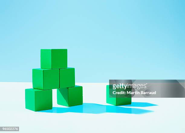 stack of green blocks - exclusion concept stock pictures, royalty-free photos & images