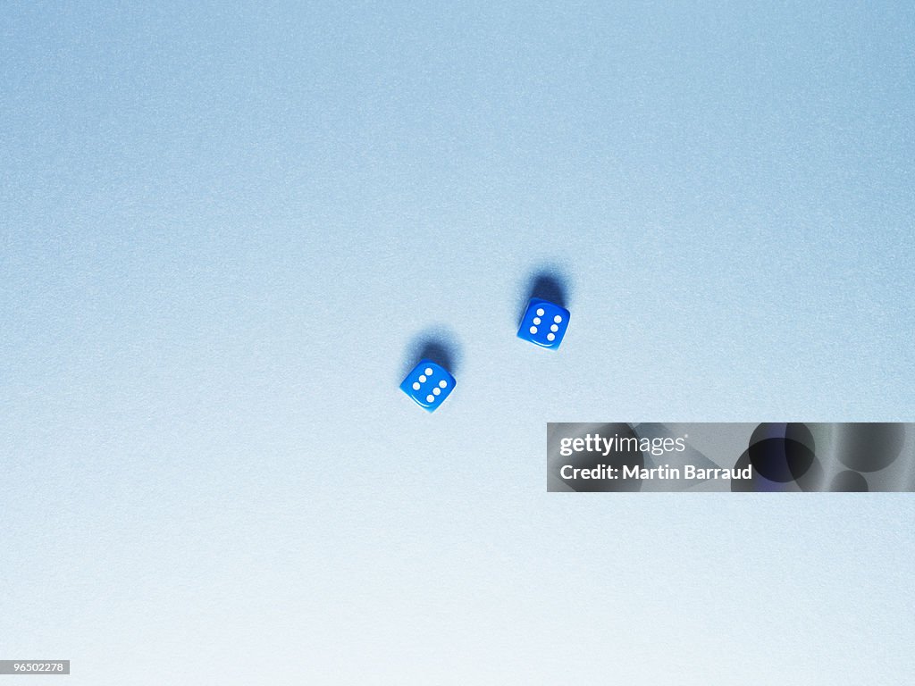 Directly above two blue dice