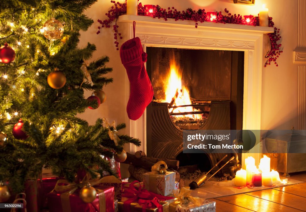 Christmas tree and stocking near fireplace