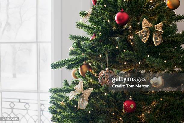 christmas ornaments on tree - christmas tree stock pictures, royalty-free photos & images