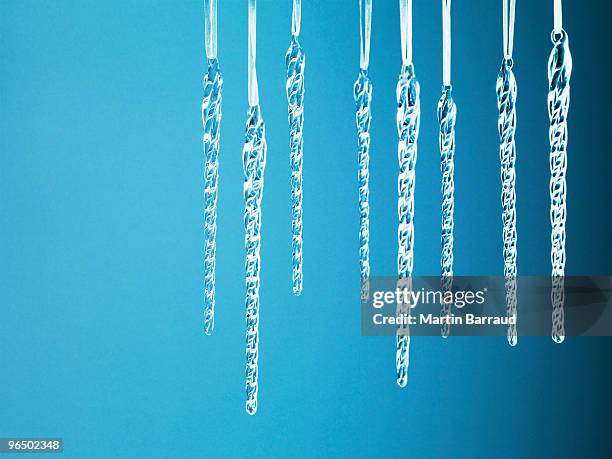 icicle christmas ornaments hanging from string - icicles isolated stock pictures, royalty-free photos & images