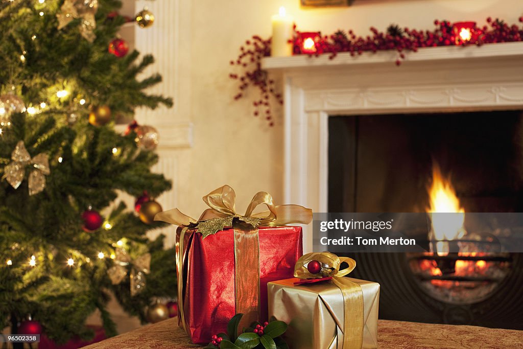 Christmas gifts near tree and fireplace