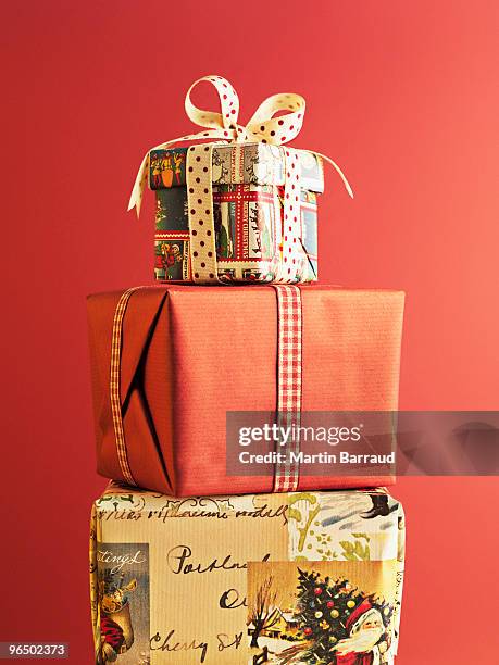 stack of christmas gifts - pile of gifts stock pictures, royalty-free photos & images