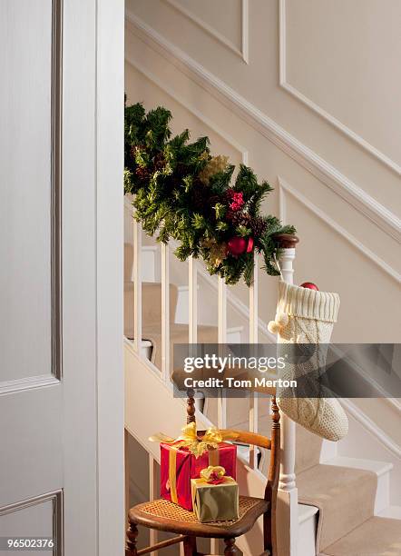 christmas gifts and stocking near staircase - bannister stock pictures, royalty-free photos & images