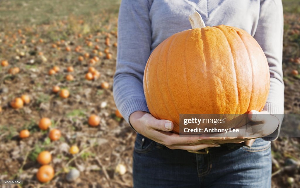 Woman holding pumpkin