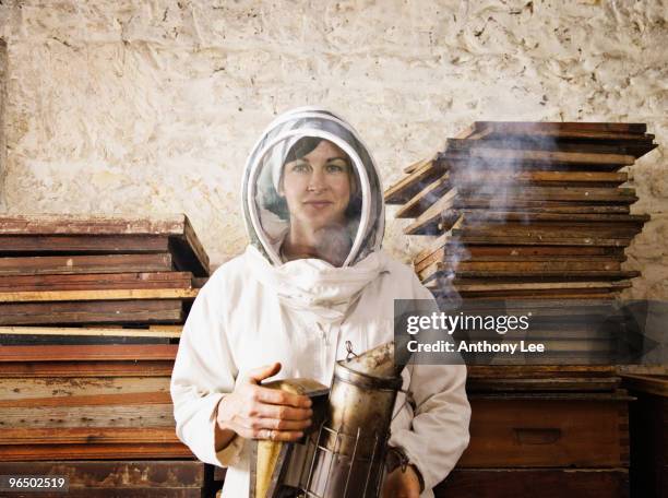 beekeeper holding smoker - bee keeper stock pictures, royalty-free photos & images