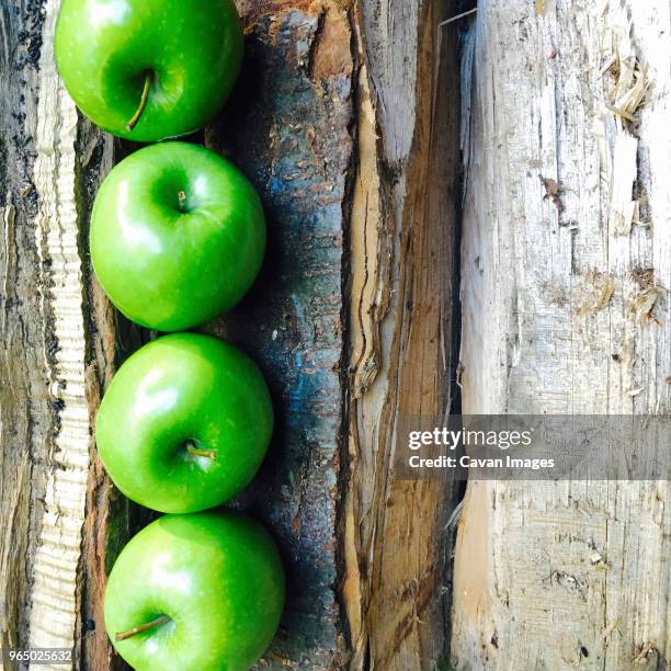 overhead view of granny smith apples on broken table - granny smith stock pictures, royalty-free photos & images