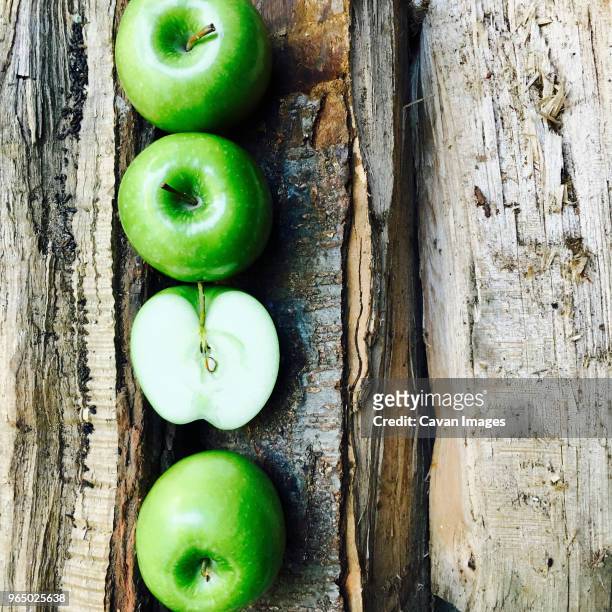 overhead view of granny smith apples arranged on broken table - granny smith stock pictures, royalty-free photos & images