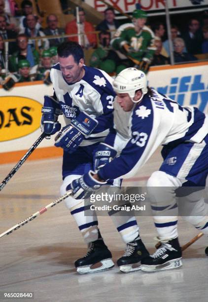 Brad Marsh and Al Iafrate of the Toronto Maple Leafs skate against the Minnesota North Stars during NHL game action November 6, 1989 at Maple Leaf...