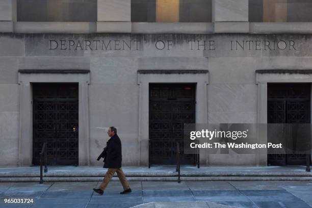 Government workers leave the Department of Interior building, unsure if they'll be back to work next week, on Friday, January 19 in Washington, DC....