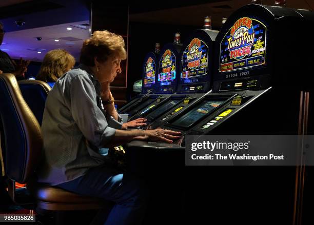 Joan Carnan plays electronic poker at an Atlantic City casino. She doesn't miss the days when her hands would get black from handling coins when she...